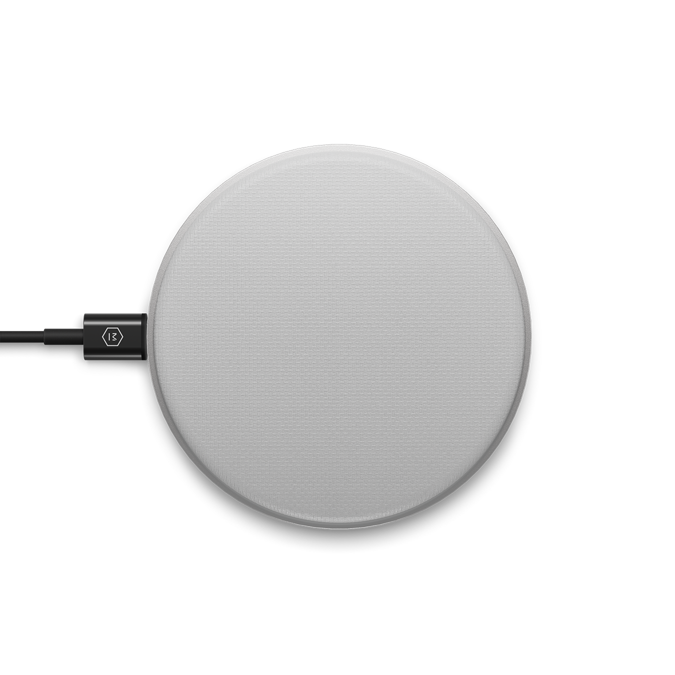 Top-down image of a silver MC100 Wireless Charge Pad plugged into a black charging cable | gallery MC100S3