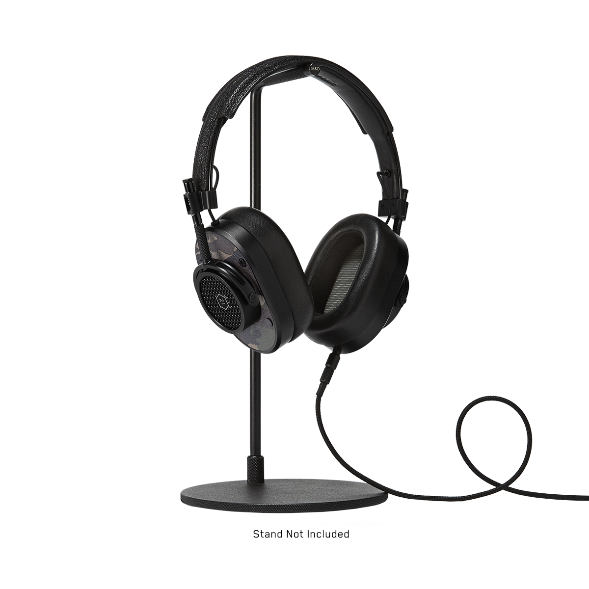 3/4 view of MH40 Wired Headphones in black and camo leather with 3.5mm audio cable attached, shown on a headphone stand which is not included | gallery MH40B9