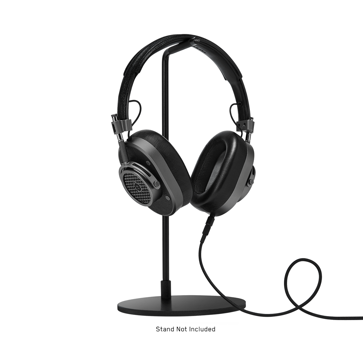 3/4 view of MH40 Wired Headphones in gunmetal and black leather with 3.5mm audio cable attached, shown on a headphone stand which is not included | gallery MH40G1