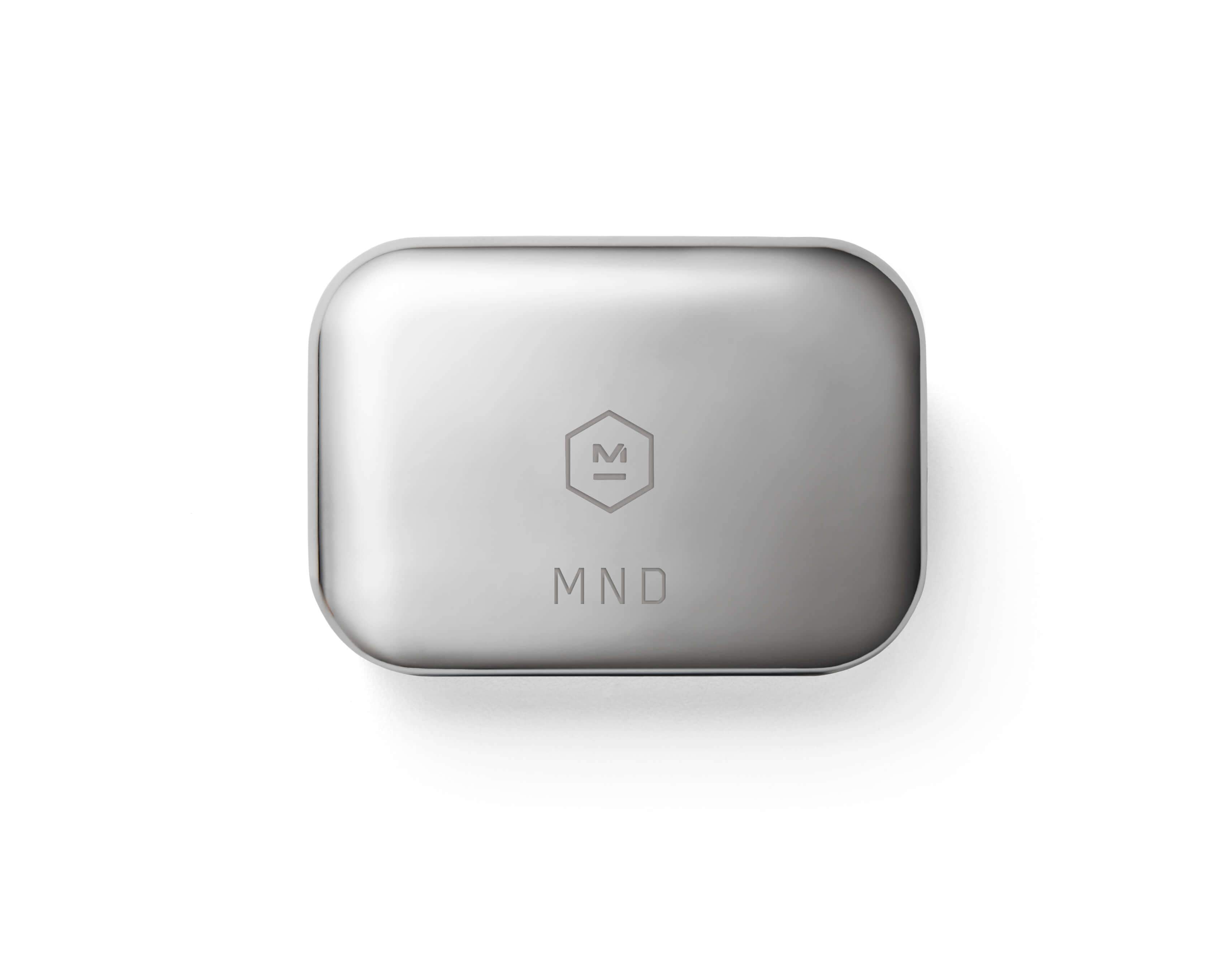 Top down image of a stainless steel MW07 True Wireless Earphones case featuring Master & Dynamic logo and custom engraving with the letters M N D |