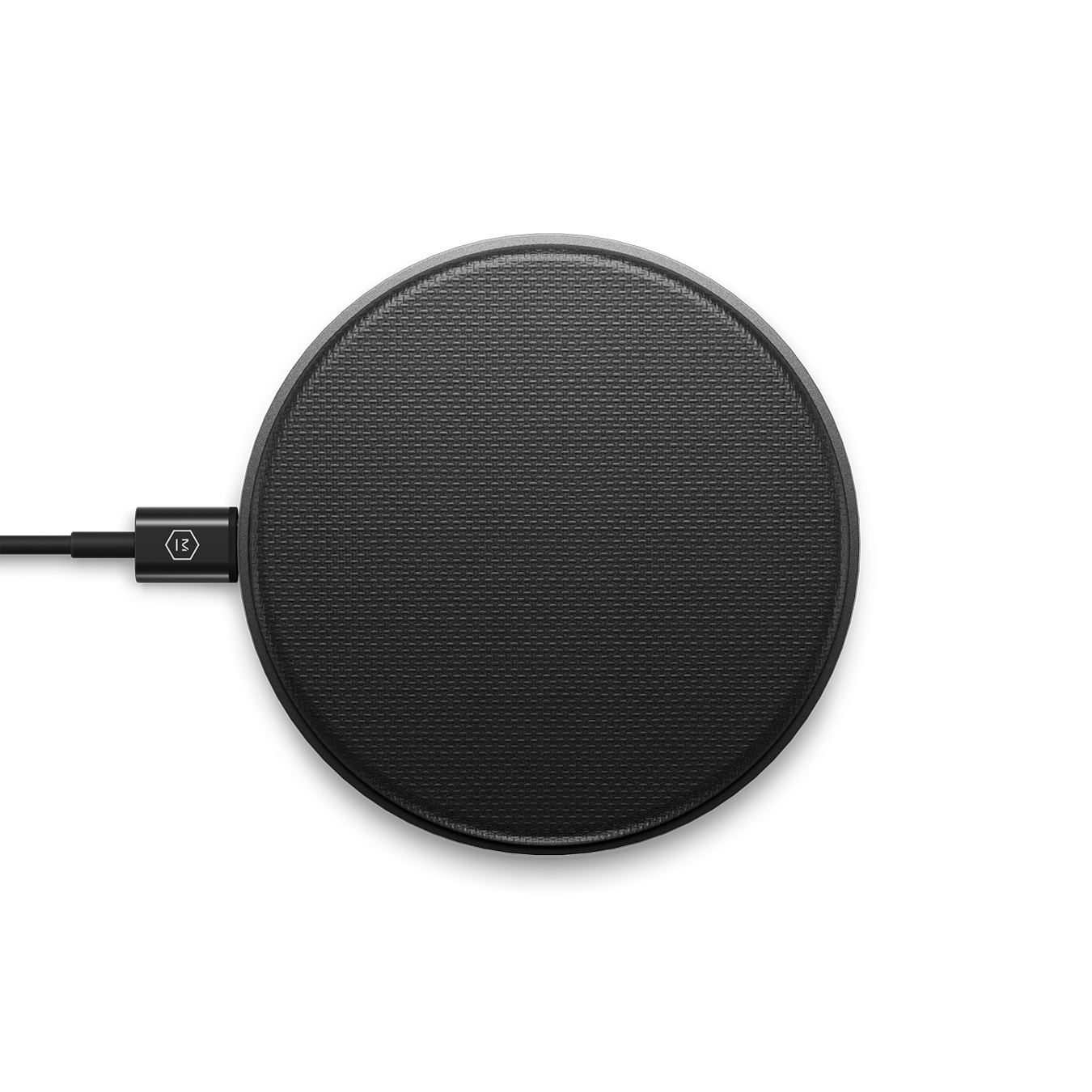 Top-down image of a gunmetal MC100 Wireless Charge Pad plugged into a black charging cable | gallery MC100G1