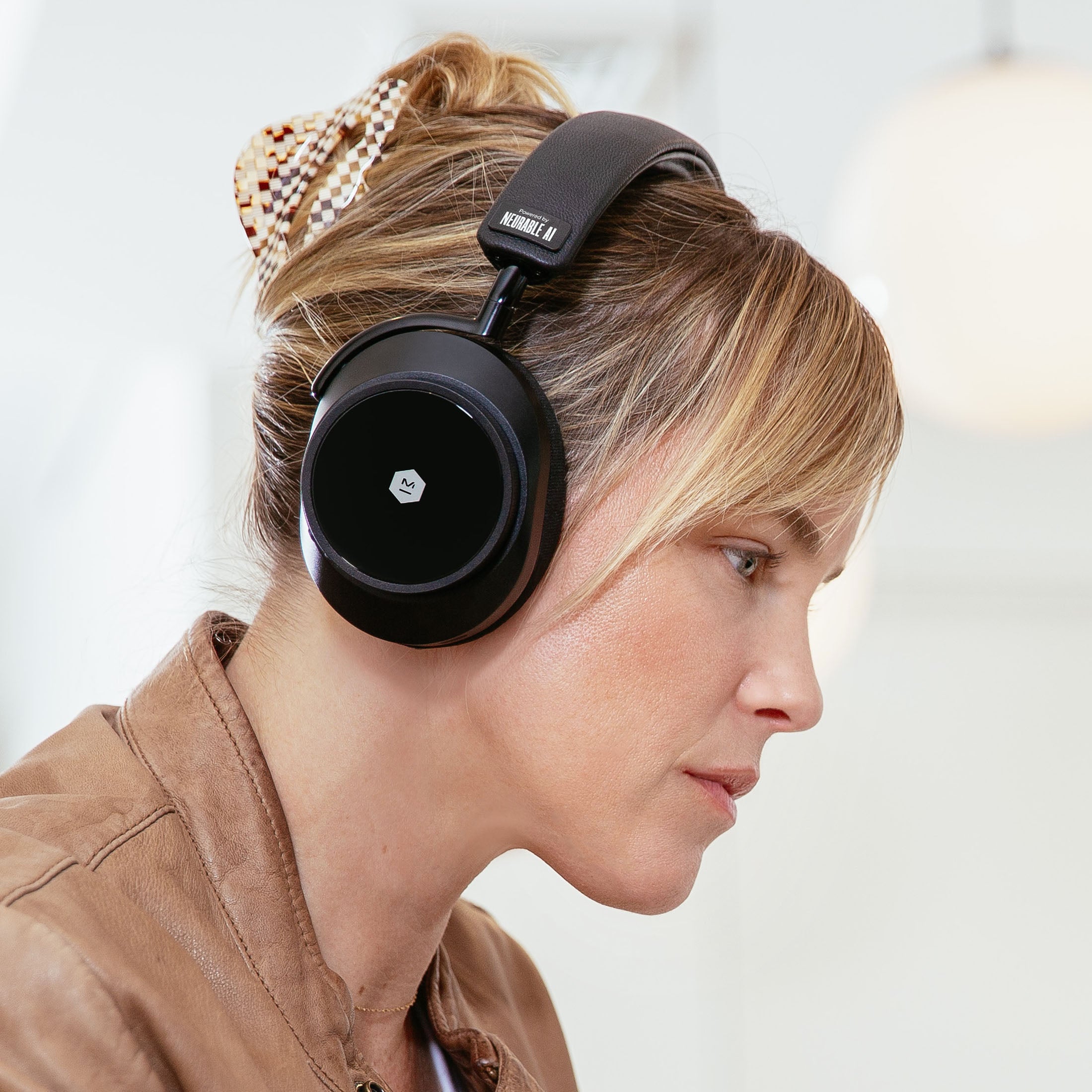 Side view of a blonde woman wearing black MW75 Neuro EEG Active Noise-Cancelling Headphones on a white background | gallery MW75B-Neuro