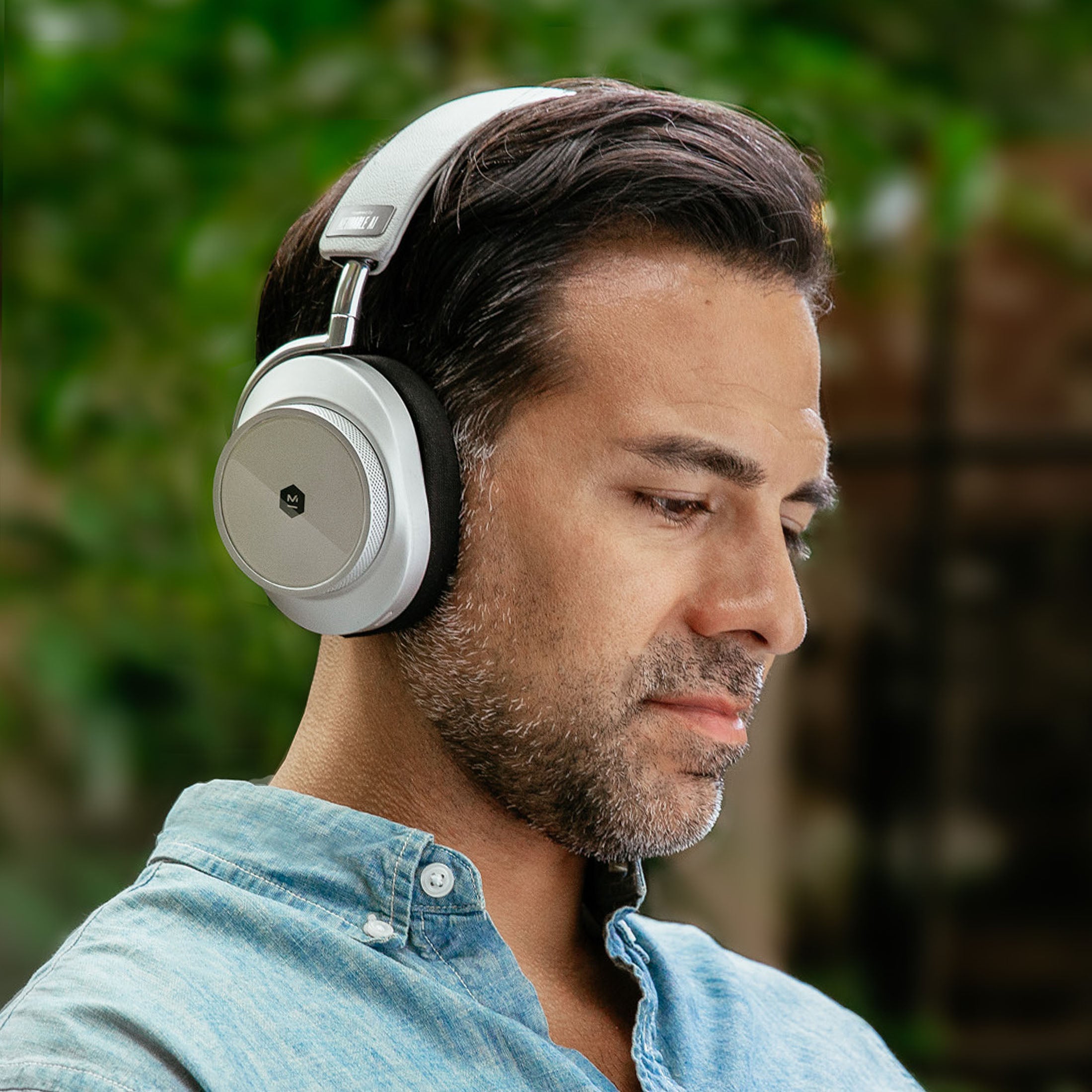Man in a blue shirt wearing black MW75 Neuro EEG Active Noise-Cancelling Headphones outdoors | gallery MW75S-Neuro
